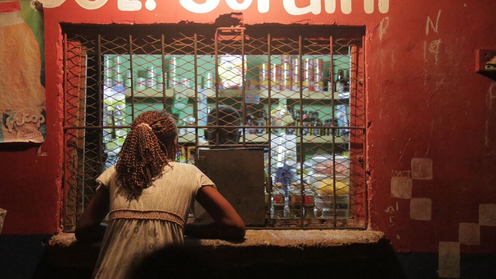 At night, standing outside of a vendor's window.